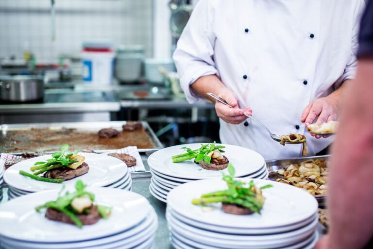 Chef plating dishes in a restaurant kitchen